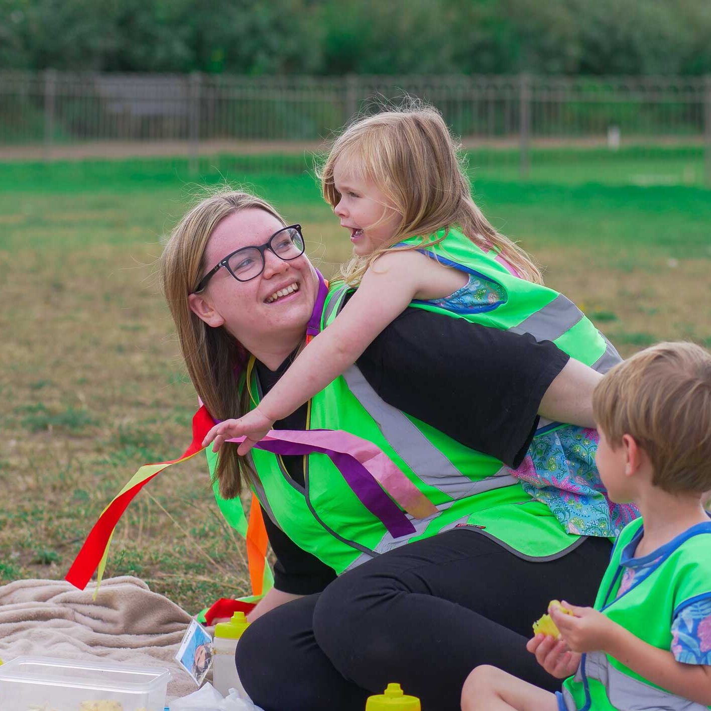 educator with child on back both smiling